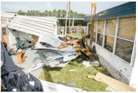  ?? DOUGLAS R. CLIFFORD/TAMPA BAY TIMES ?? The National Weather Service’s Tampa Bay office confirmed four tornadoes hit last week in addition to two previously confirmed. Pictured are building materials that lay between mobile homes in Dunedin that were damaged.