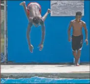  ??  ?? Diving in: Jacaleb Miles dives into the water at Mattocks Park Pool Friday.