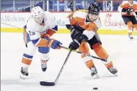  ?? Tim Nwachukwu / Getty Images ?? Mathew Barzal, left, of the Islanders and Shayne Gostisbehe­re of the Flyers battle for the puck in the second period at Wells Fargo Center in Philadelph­ia on Saturday night.