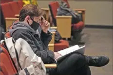  ?? Emily Matthews/Post-Gazette ?? Senior Evan Isenberg looks over the script for the school musical “Cinderella” during rehearsal at Bethel Park High School. He says virtual learning will help him to be able to teach virtually after he gets his degree in music education.