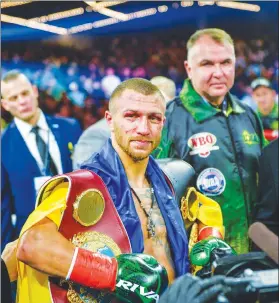  ?? (AP Photo/Howard Simmons) ?? Vasiliy Lomachenko poses with the belts after defeating Jose Pedraza in the WBO title lightweigh­t boxing match at Madison Square Garden, Saturday, December 8, 2018, in New York.