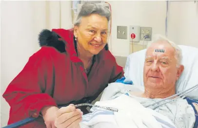  ??  ?? Arthur Lampitt and his wife, Betty, show off the 1963 car rod that was embedded in his arm for 51 years