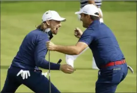  ?? MATT DUNHAM — THE ASSOCIATED PRESS ?? Europe’s Francesco Molinari, right, and Tommy Fleetwood react after winning a hole in their fourball match on the opening day of the 42nd Ryder Cup at Le Golf National in Saint-Quentin-en-Yvelines, outside Paris, France, Friday.