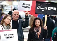  ?? — AFP ?? Jewish and Arab Israelis display placards during an anti-war demonstrat­ion in Baqa Al Gharbiyye. Placards read in Hebrew “Stop the war” and in Hebrew and Arabic “Life” .