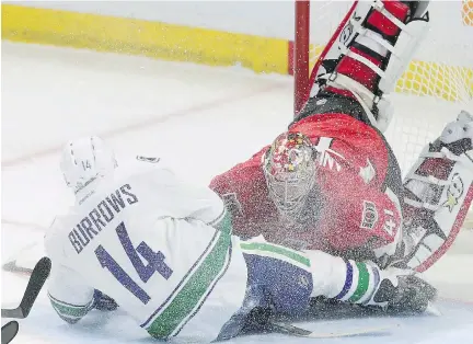  ??  FRED CHARTRAND/ THE CANADIAN PRESS FILES ?? Vancouver Canucks’ Alexandre Burrows collides with Ottawa Senators’ goaltender Craig Anderson during recent NHL action. Goaltendin­g interferen­ce heads the agenda for the annual March meetings in Baton Roca, Fla.