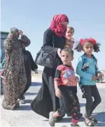  ?? — AFP ?? Syrians arrive at the Abu Duhur crossing on the eastern edge of Idlib province on Tuesday as they cross from rebel-held areas to regime-held areas.