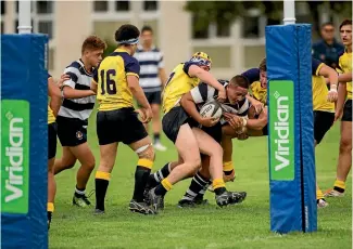  ?? PHOTO: DAVID UNWIN/FAIRFAX NZ ?? PNBHS prop Isaiah Fonongolea wrestles his way to the try line against Scots School from Sydney in Palmerston North yesterday.