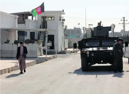  ?? Ahamad Nadeem / Reuters ?? Afghan national army soldiers stand guard near the Kandahar governor’s guesthouse. A bomb blast in the building on January 10 killed at least 12 people, among them five UAE diplomats, and wounded the UAE Ambassador to the country.