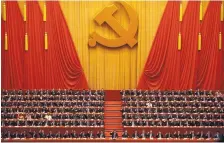  ?? ANDY WONG/ASSOCIATED PRESS ?? Chinese President Xi Jinping, front row center, leads his cadres in raising their hands to approve work reports during the closing ceremony Tuesday at the 19th Party Congress in Beijing.