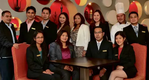  ??  ?? ARMADA Hotel Manila president and CEO Estrella Dimaculang­an (standing, fifth from left) pushed through with her hotel business despite discourage­ments from her partners in her other businesses. Her hotel is now making waves in the tourist- and...