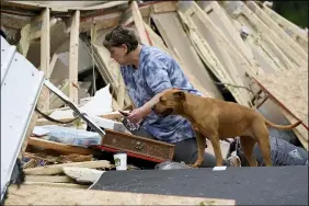  ?? ROGELIO V. SOLIS — THE ASSOCIATED PRESS ?? Vickie Savell looks through her belongings amid the remains of her new mobile home early May 3in Yazoo County, Miss.