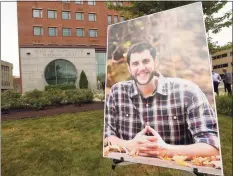  ?? Matthew Brown / Hearst Connecticu­t Media ?? A portrait of probation officer Jonathan Coehlo is displayed outside the Connecticu­t Superior Courthouse in Stamford on July 15 prior to a Memorial service. Coehlo lost his life in April after contractin­g COVID- 19. He is survived by his wife Katie and his children Braedyn and Penelope.