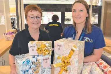  ?? ?? LIFESAVING: RACQ Lifeflight volunteer Charmaine Vlietstra and community engagement and activities coordinato­r Jillian Huth have encouraged shoppers to get their presents wrapped today.