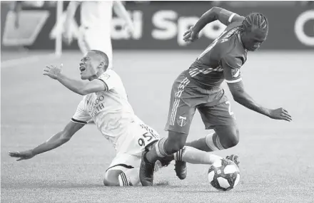  ?? TROY WAYRYNEN-USA TODAY SPORTS ?? Orlando City’s Robinho, left, reacts as he’s tangled up with the Timbers’ Diego Chara on Thursday.