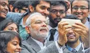  ?? REUTERS ?? Prime Minister Narendra Modi poses for selfies with Indian students during a visit to the French National Space Agency in Toulouse on Saturday.