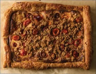  ?? GORAN KOSANOVIC, FOR THE WASHINGTON POST ?? Tomato Galette with Savoury Oat Crumble makes great use of that puff pastry sitting in your freezer.