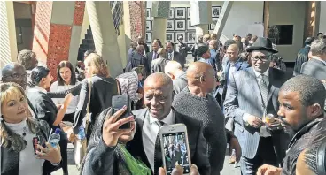  ?? Picture: CARLOS AMATO ?? MOMENT OF REFLECTION: People at Friday’s farewell for Deputy Chief Justice Dikgang Moseneke clamour to take selfies with him outside the Constituti­onal Court, while trade unionist Zwelinzima Vavi, in hat, looks on