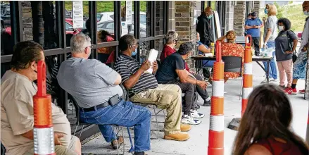  ?? NATI HARNIK / ASSOCIATED PRESS ?? Job seekers wait to be called into Heartland Workforce Solutions in Omaha, Nebraska, on July 15. Nebraska reinstated job search requiremen­ts for most people claiming jobless benefits. Those requiremen­ts were suspended in mid-March.