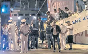  ?? AP ?? Some of the 67 migrants rescued at sea by the ‘Vos Thalassa’ freighter disembark from the Italian Coast Guard ship ‘Diciotti’ in Trapani yesterday.