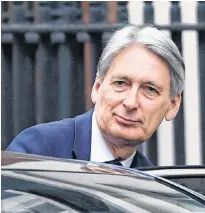  ?? AP PHOTO ?? Britain’s Chancellor of the Exchequer Philip Hammond leaves Downing Street in London, ahead of Prime Minister’s Questions at the House of Commons, Wednesday. Prediction­s of slumping industrial output across the 19-country eurozone is stoking talk of a possible recession in the early months of 2019, even before factoring in the prospect of a disorderly Brexit next month.