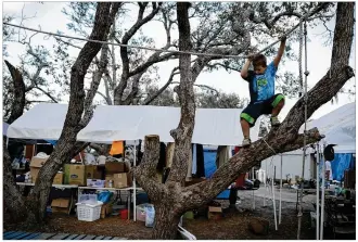  ?? JAY JANNER / AMERICAN-STATESMAN ?? Gage Combs, 8, plays last month at the relief camp in Rockport. Gage was living with his parents and three siblings in a donated trailer at the camp three months after Hurricane Harvey destroyed their house. Many residents of Harvey-affected towns are...