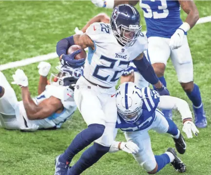  ?? TREVOR RUSZKOWSKI/USA TODAY SPORTS ?? Titans running back Derrick Henry carries for a touchdown against the Colts on Sunday in Indianapol­is. Henry ran for 178 yards and three touchdowns in a 45-26 victory.