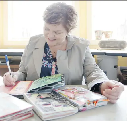  ?? — LEAH HENNEL/CALGARY HERALD FILES ?? Breast cancer survivor Dorothy Mackintosh, 48, works on her journals, which she credits with helping her to recover physically and emotionall­y after her diagnosis.