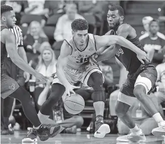  ?? THE ASSOCIATED PRESS ?? Texas A&M center Tyler Davis tries to dribble between Buffalo guard CJ Massinburg, left, and forward Ikenna Smart during their Dec. 21 game in College Station, Texas. The Aggies are 11-1 as they prepare to open SEC play Saturday at Alabama.