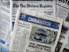  ?? CHARLIE NEIBERGALL - THE ASSOCIATED PRESS ?? This Friday, Oct. 19 photo shows a copy of the four-page advertisin­g section Chinawatch along with a copy of The Des Moines Register in Des Moines, Iowa. China’s propaganda machine has taken aim at American soybean farmers as part of its high-stakes trade war with the Trump administra­tion. The publicatio­n last month of the four-page advertisin­g section in the Register opened a new battle line in China’s effort to break the administra­tion’s resolve.
