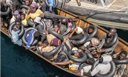  ?? Photograph: Anadolu Agency/Getty ?? A migrant boat is detained off the Tunisian coast.