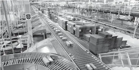  ?? PATRICK SEMANSKY, ASSOCIATED PRESS ?? Packages bound for the eastern U.S. ride a conveyor system at an Amazon facility in Baltimore.