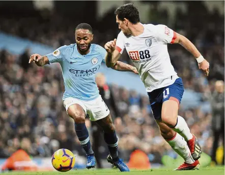  ??  ?? Moving in quick: Manchester City’s Raheem Sterling (left) vying for the ball with Bournemout­h’s Charlie Daniels during the English Premier League match at the Etihad on Saturday. — AP