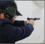 ?? ALI RIZVI/MCCLATCHY ?? Joshua Savani of the National Rifle Associatio­n demonstrat­es a handgun with a silencer in Fairfax, Va., on March 20.