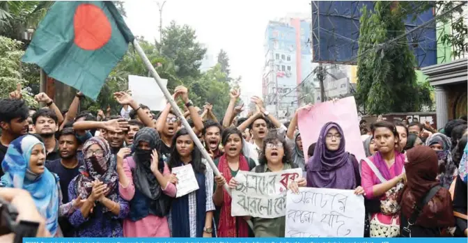  ?? — AFP ?? DHAKA: Bangladesh­i students shout slogans as they march along a street during a student protest in Dhaka yesterday following the deaths of two college students in a road accident.