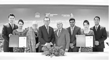  ??  ?? (Third left) Destinatio­n NSW chief executive officer Sandra Chipchase, Marshall, Yeoh and Singapore Airlines senior manager of brand and Marketing Ranjan Jha together with Singapore Airlines cabin crew at the signing ceremony of the MoU between Singapore Airlines and Destinatio­n New South Wales.