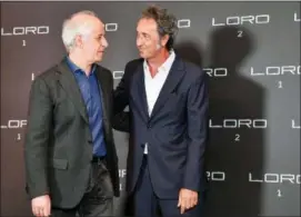  ?? ALESSANDRO DI MEO — ANSA VIA AP ?? Italian director Paolo Sorrentino and actor Toni Servillo, left, share a moment during the photocall of Sorrentino’s latest film “Loro 2”, in Rome, Wednesday.