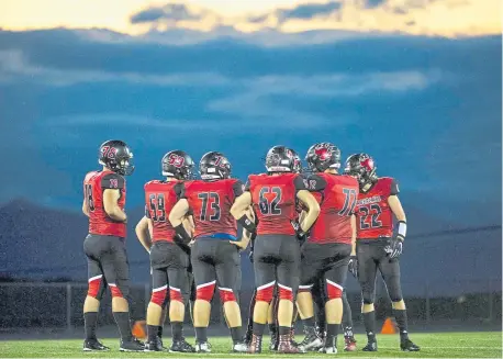  ?? Timothy Nwachukwu, The Denver Post ?? The Castle View Sabercats huddle between plays against the Arapahoe Warriors at Douglas County Stadium in 2019 in Castle Rock. The timeline for fall high school sports remains uncertain.