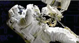  ?? NASA / ASSOCIATED PRESS ?? NASA astronaut Joe Acaba performs a spacewalk outside the Internatio­nal Space Station on Friday. Acaba was outside barely an hour when he had to replace one of his safety tethers, which had become frayed and worn.