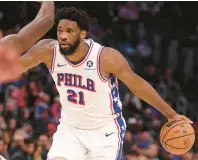  ?? GREGORY SHAMUS/GETTY ?? The 76ers’ Joel Embiid controls the ball against the Pistons’ Isaiah Stewart during the first half at Little Caesars Arena on Wednesday in Detroit, Michigan.