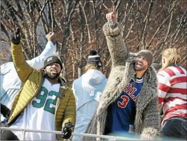  ?? GENE WALSH — DIGITAL FIRST MEDIA ?? Eagles players Fletcher Cox and Chris Long wave to fans during the team’s Super Bowl Victory Parade along Broad Street Thursday.