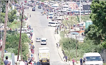  ?? (File pic) ?? Commuters walking from the Manzini Bus Rank.