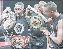  ?? (Pic: SuperSport.com) ?? WBO Global junior bantamweig­ht champion Sikho ‘Sequence’ Nqothole celebratin­g with his titles on Thursday night in Sandton, Johannesbu­rg.