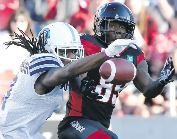  ??  ?? Argonauts defensive back Akwasi Owusu-Ansah, left, knocks down a pass intended for Redblacks wide receiver Dominique Rhymes during first half action on Saturday night in Ottawa. The Argos rallied with 25 second-half points to nip the Redblacks 26-25. —...