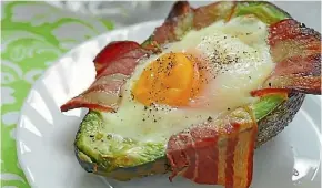  ?? 123RF ?? Avocado with egg and bacon – a ketogenic breakfast.