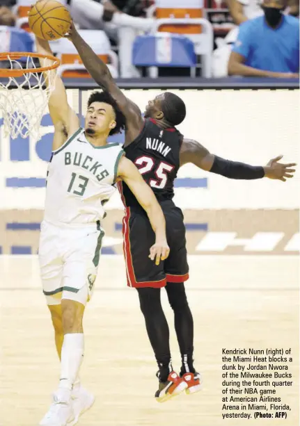  ?? (Photo: AFP) ?? Kendrick Nunn (right) of the Miami Heat blocks a dunk by Jordan Nwora of the Milwaukee Bucks during the fourth quarter of their NBA game at American Airlines Arena in Miami, Florida, yesterday.