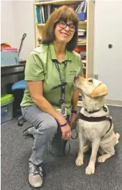  ?? STAFF PHOTO BY MARK KENNEDY ?? Ann Roberts, 48, and her service dog, Rosalie, volunteer two days a week at Erlanger hospital.