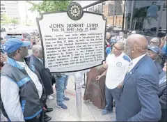  ?? MARK HUMPHREY — THE ASSOCIATED PRESS ?? People look at a new historical marker rememberin­g former Rep. John Lewis after it was unveiled Friday in Nashville, Tenn.