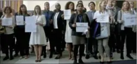  ?? BEBETO MATTHEWS -THE ASSOCIATED PRESS ?? United Nations staff, some holding signs, stand in a silent protest against a U.N. meeting to designate Wonder Woman as an “Honorary Ambassador for the Empowermen­t of Women and Girls,” Friday, at U.N. headquarte­rs.