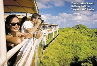  ??  ?? Tourists ride Scenic Railway built on “sugar train” tracks.