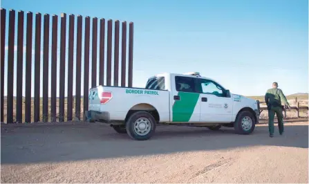  ?? — AFP ?? A US Border Patrol agent checks the area near the border fence in Columbus, New Mexico, on the US/Mexico border.